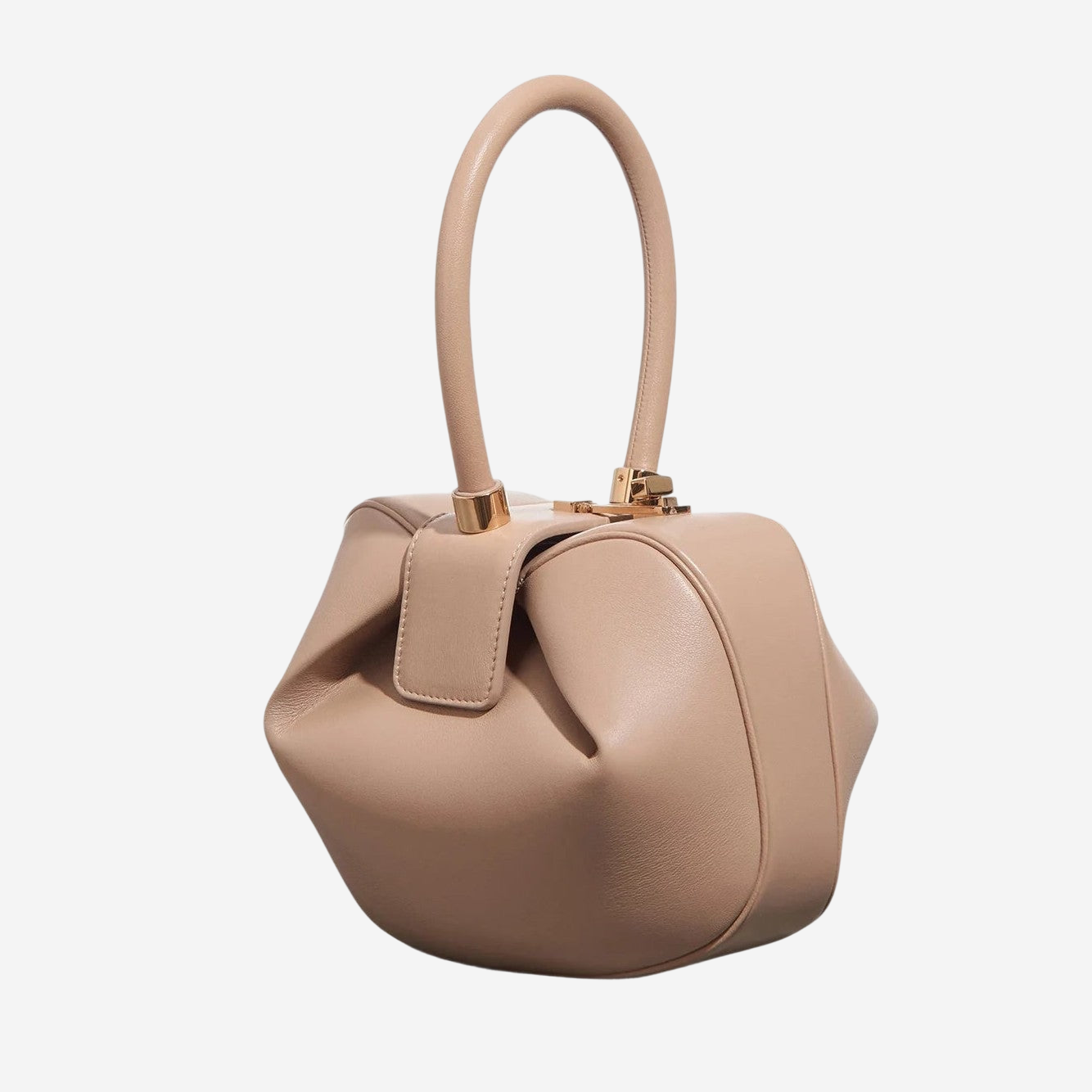 A tan leather handbag with a curved handle and gold hardware.