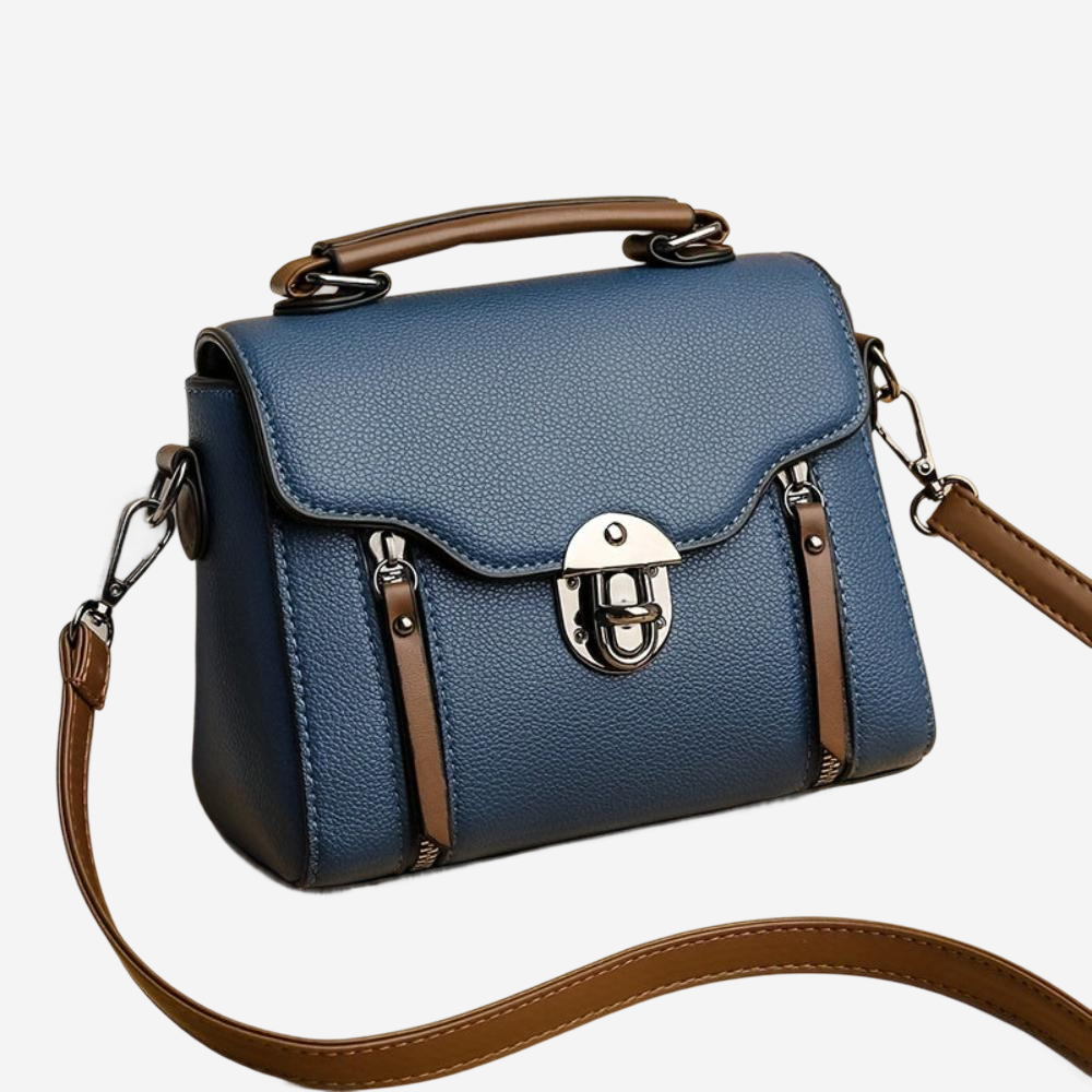 A blue leather handbag with a brown leather strap and a metal clasp.