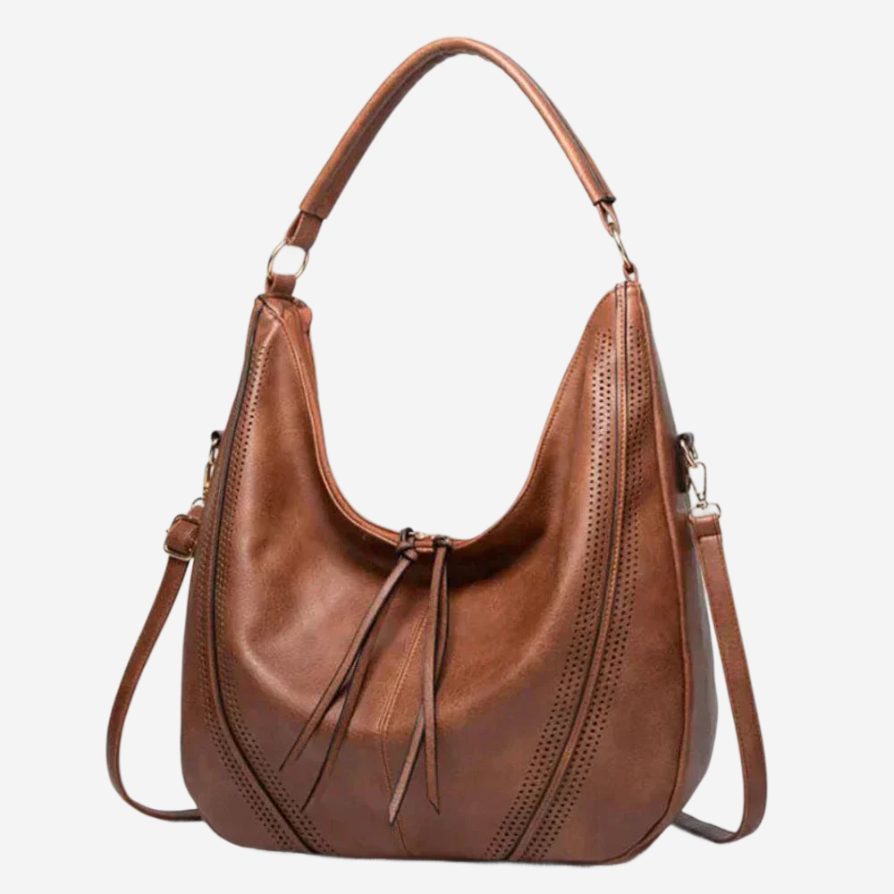 A brown leather handbag with a curved handle and multiple zippers.