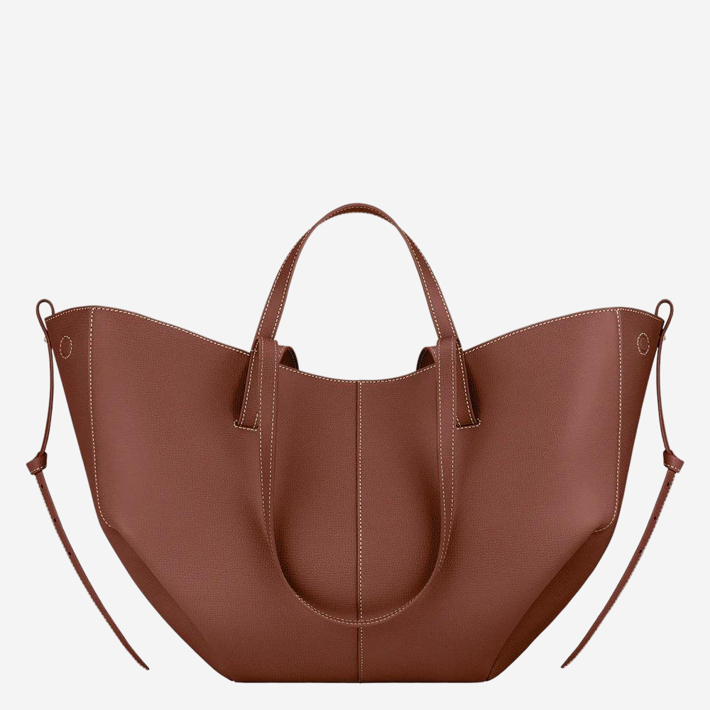 A brown leather tote bag with a curved shape and two handles.