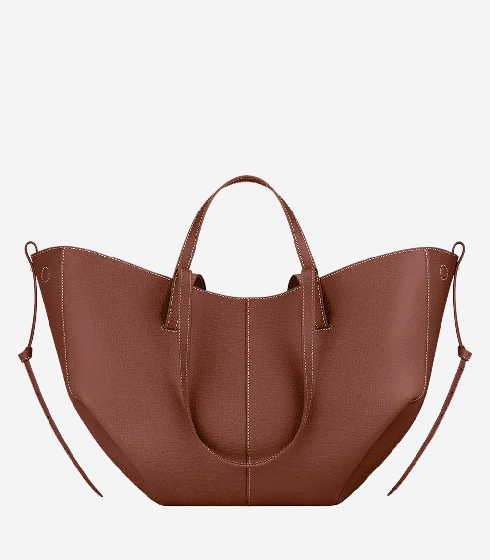 A brown leather tote bag with a curved shape and two handles.