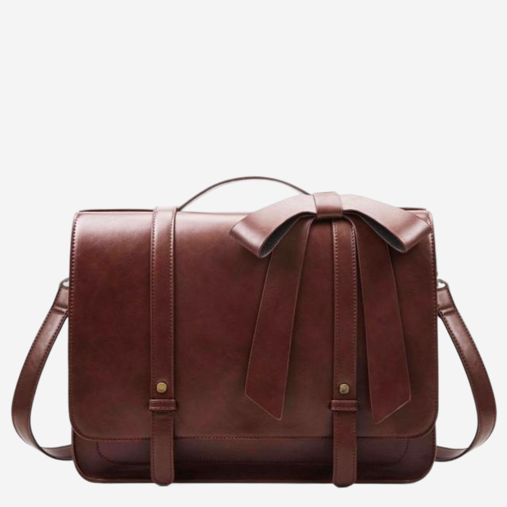 A brown leather handbag with a bow detail on the front.
