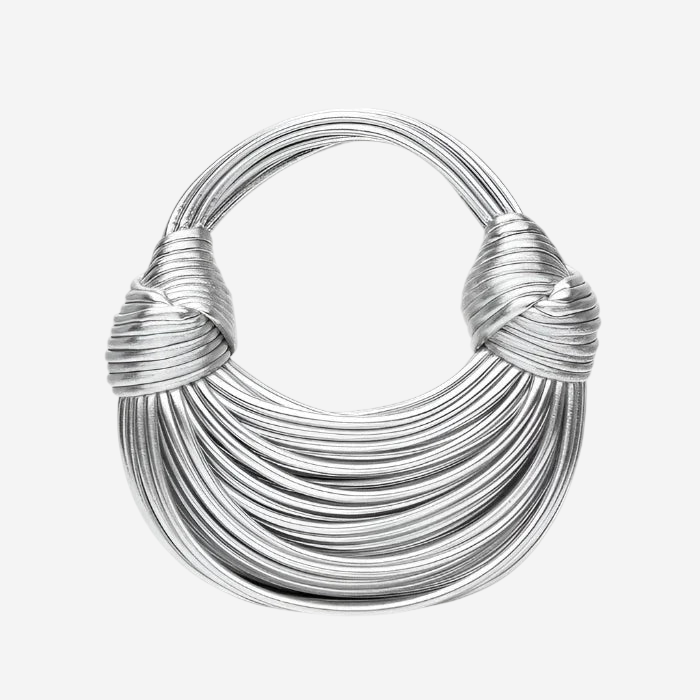 A silver necklace with multiple strands of twisted metal forming a circular shape.
