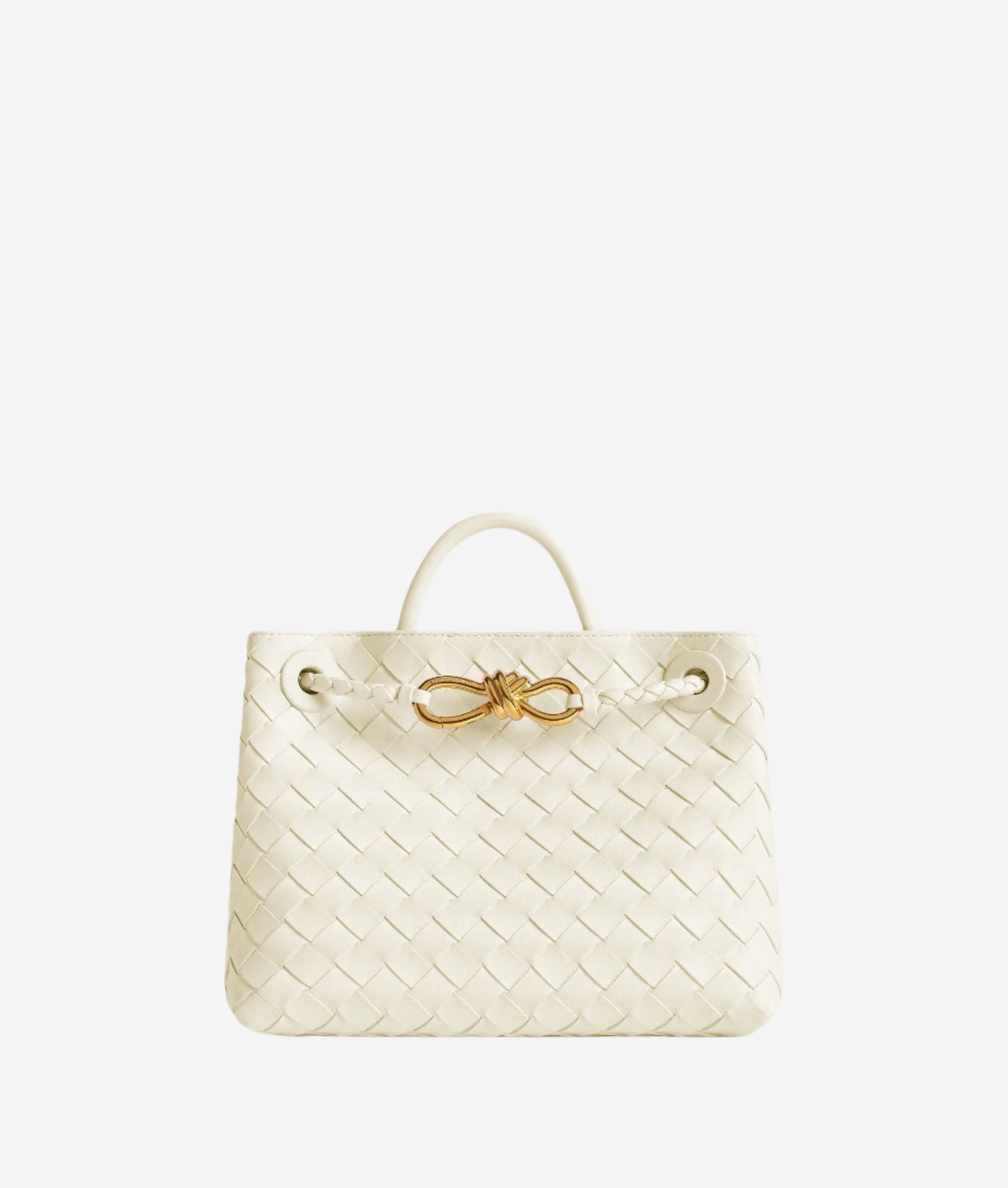 A white woven handbag with a gold clasp and handle.