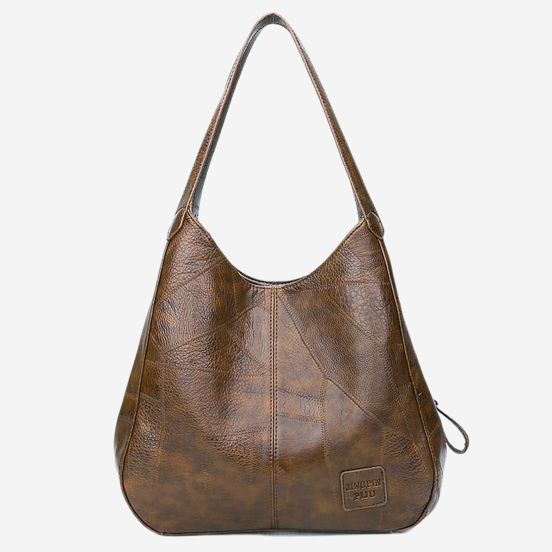 A brown leather handbag with a curved handle and a small tag on the front.
