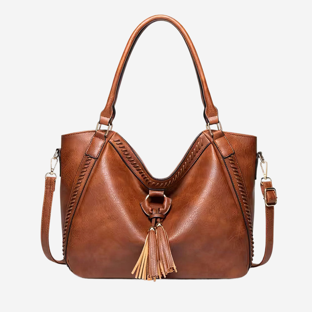 A brown leather handbag with a curved handle and tassel hanging from the front.