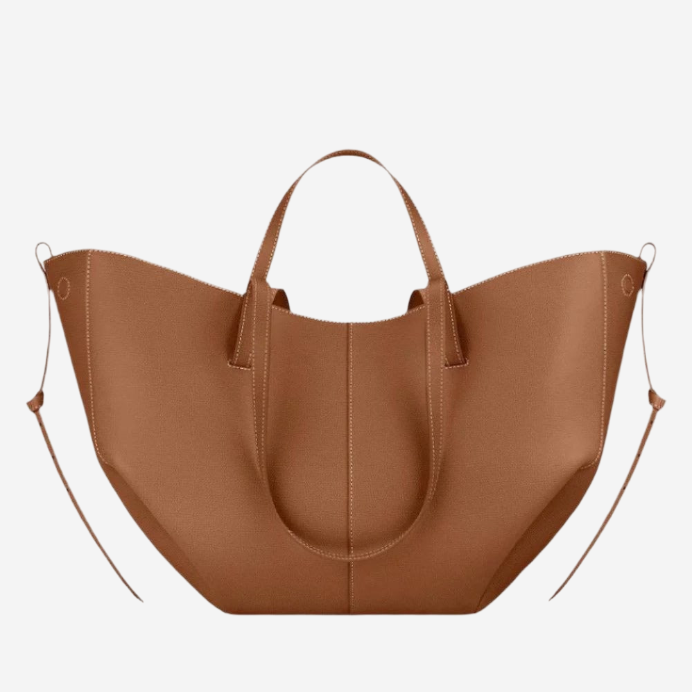A brown leather tote bag with a curved handle and two shoulder straps.