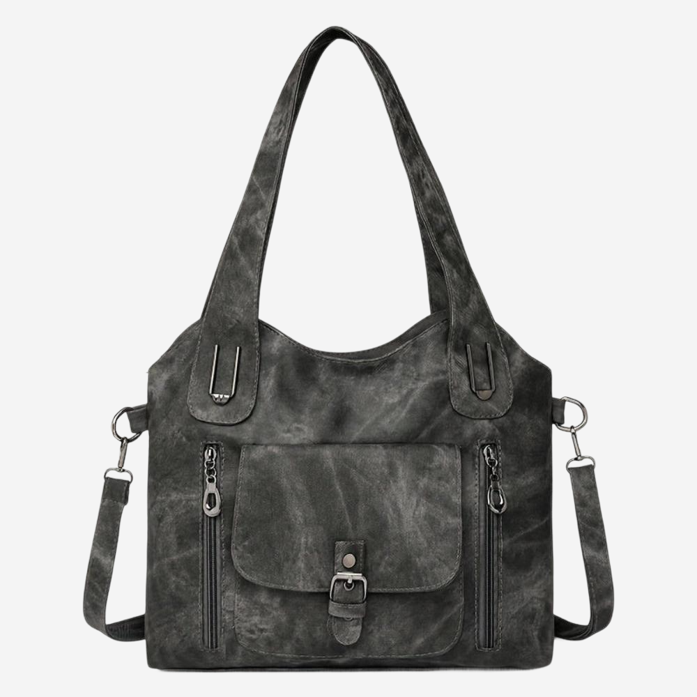 A black leather tote bag with multiple zippers and a front pocket.