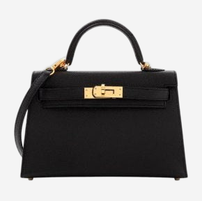 A black leather handbag with gold hardware, including a lock and clasp, and a gold strap.