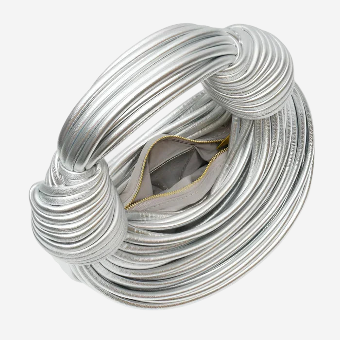 A silver, twisted metal ring with a zipper pocket inside.