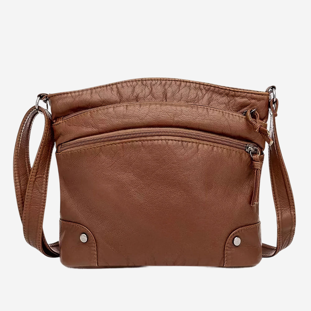 A brown leather crossbody bag with multiple pockets and zippers.