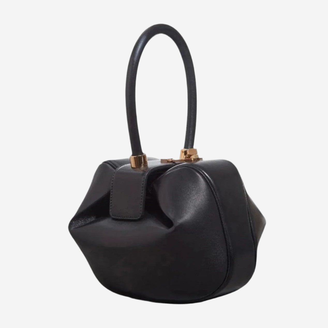 A black leather handbag with a curved handle and gold hardware.