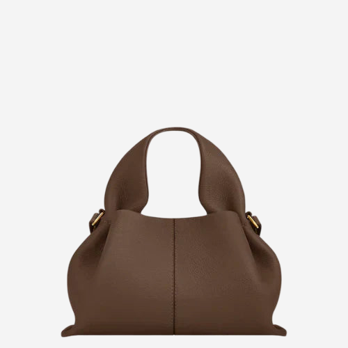 A brown leather handbag with a curved handle and two gold-colored buckles.