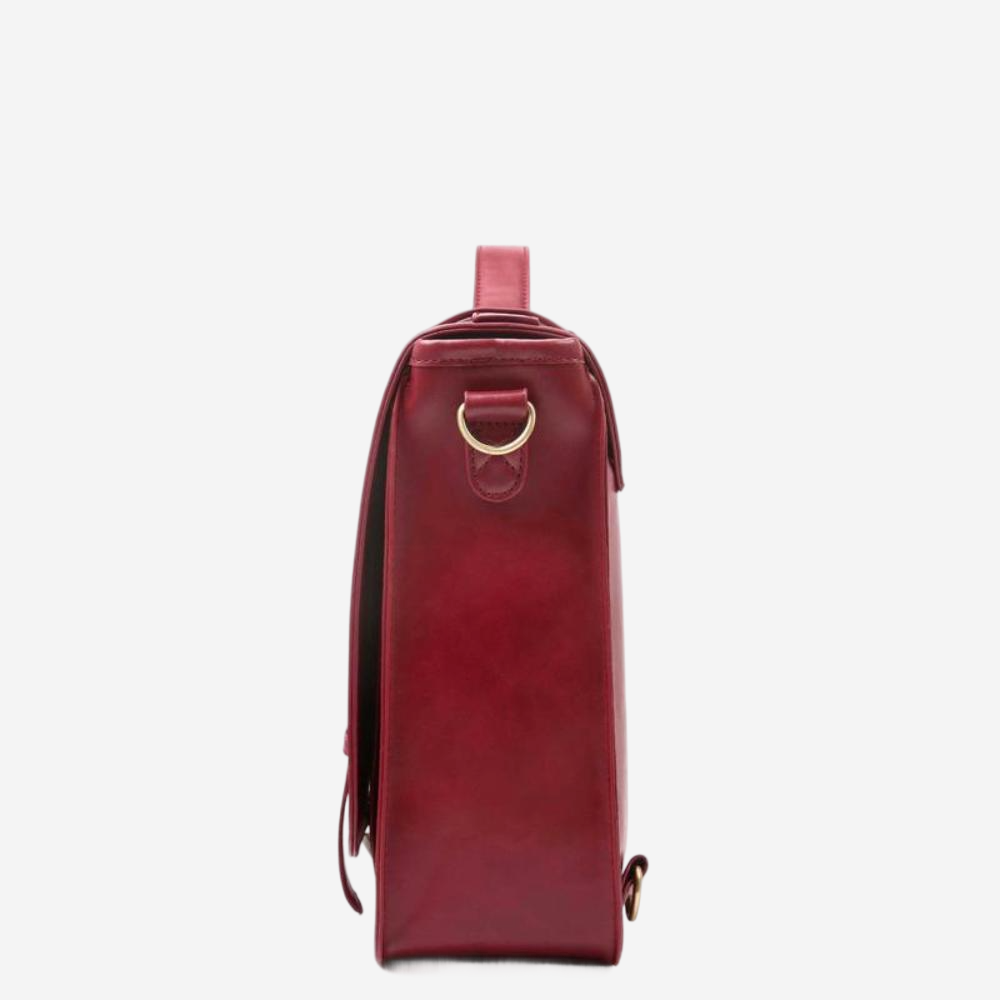 A red leather satchel with a gold metal clasp and a small metal loop on the front.