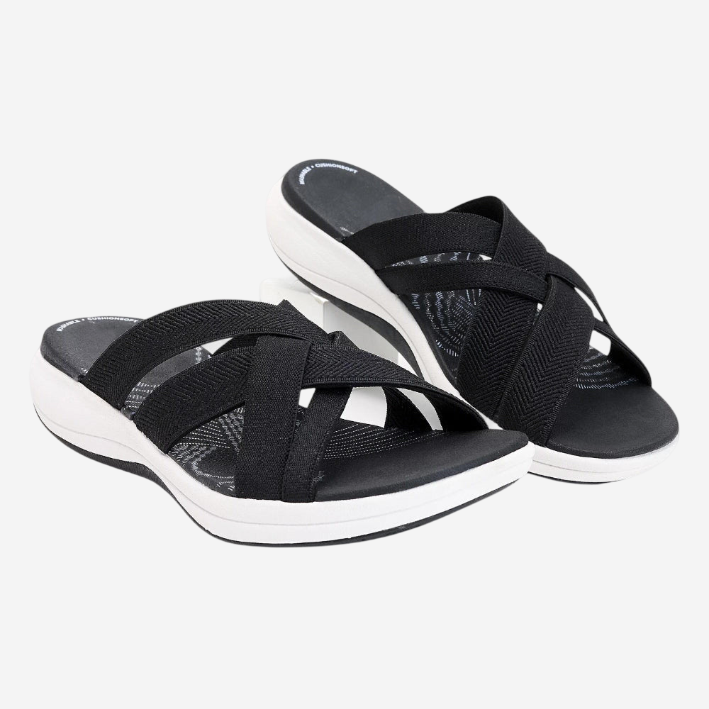 A pair of black and white sandals with a woven strap design.