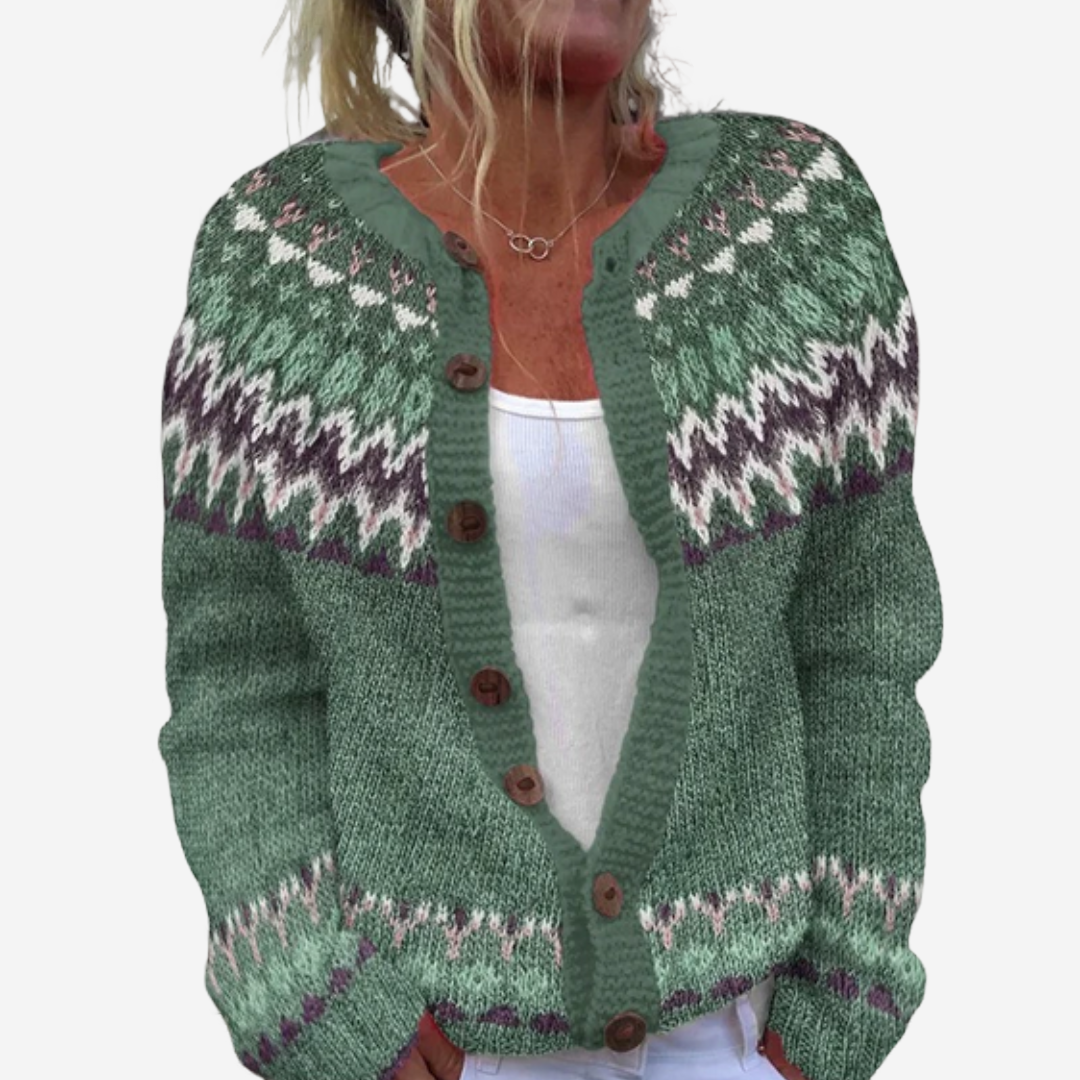 A woman wearing a green and white knitted cardigan with a patterned design.