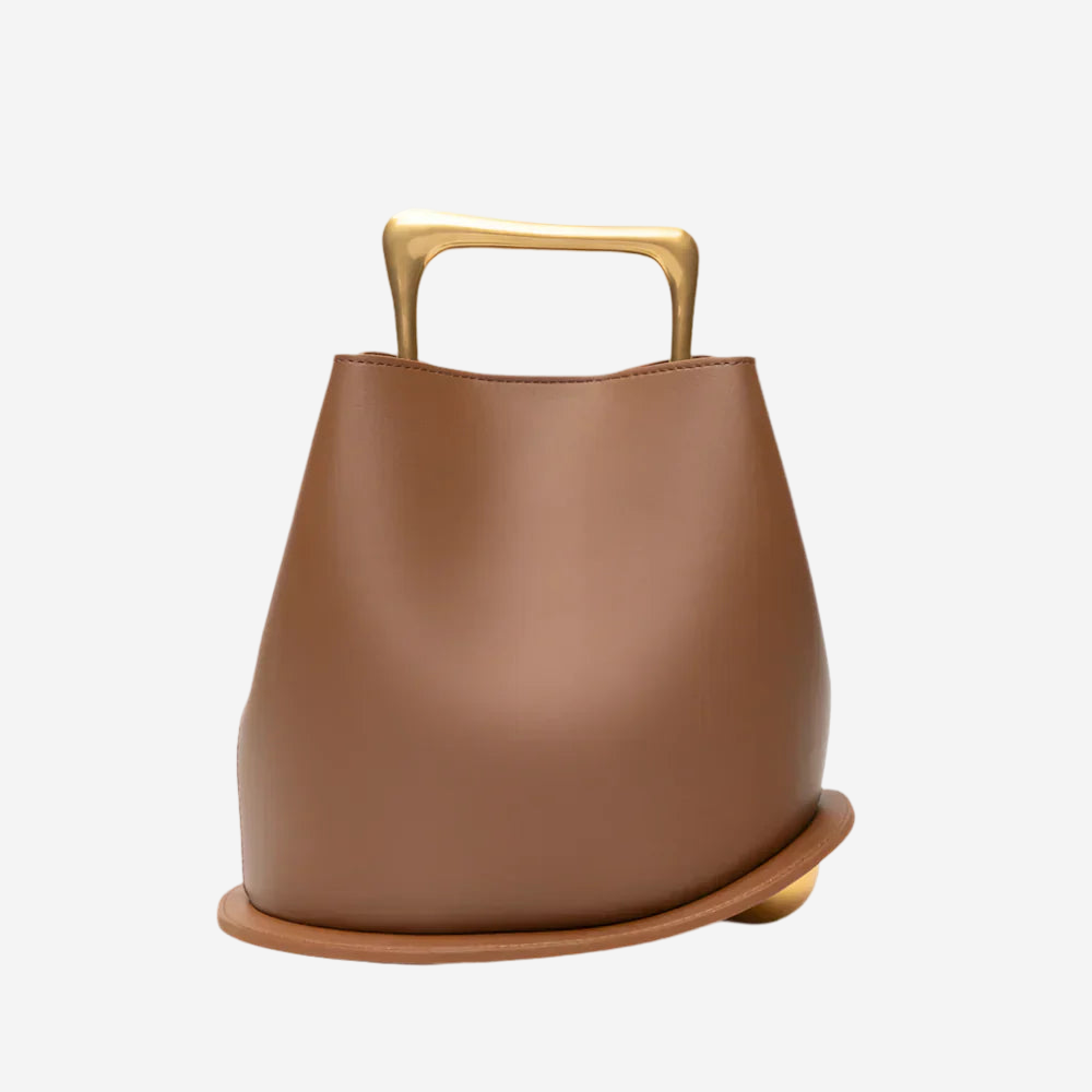 A brown leather handbag with a gold handle and strap.