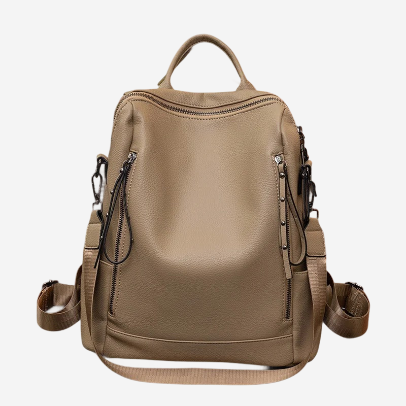 A tan leather backpack with multiple zippers and straps, designed for carrying various items.