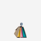 A colorful handbag with a unique design, featuring a combination of pastel and vibrant colors.