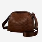 A brown leather crossbody bag with a zipper closure and a strap.