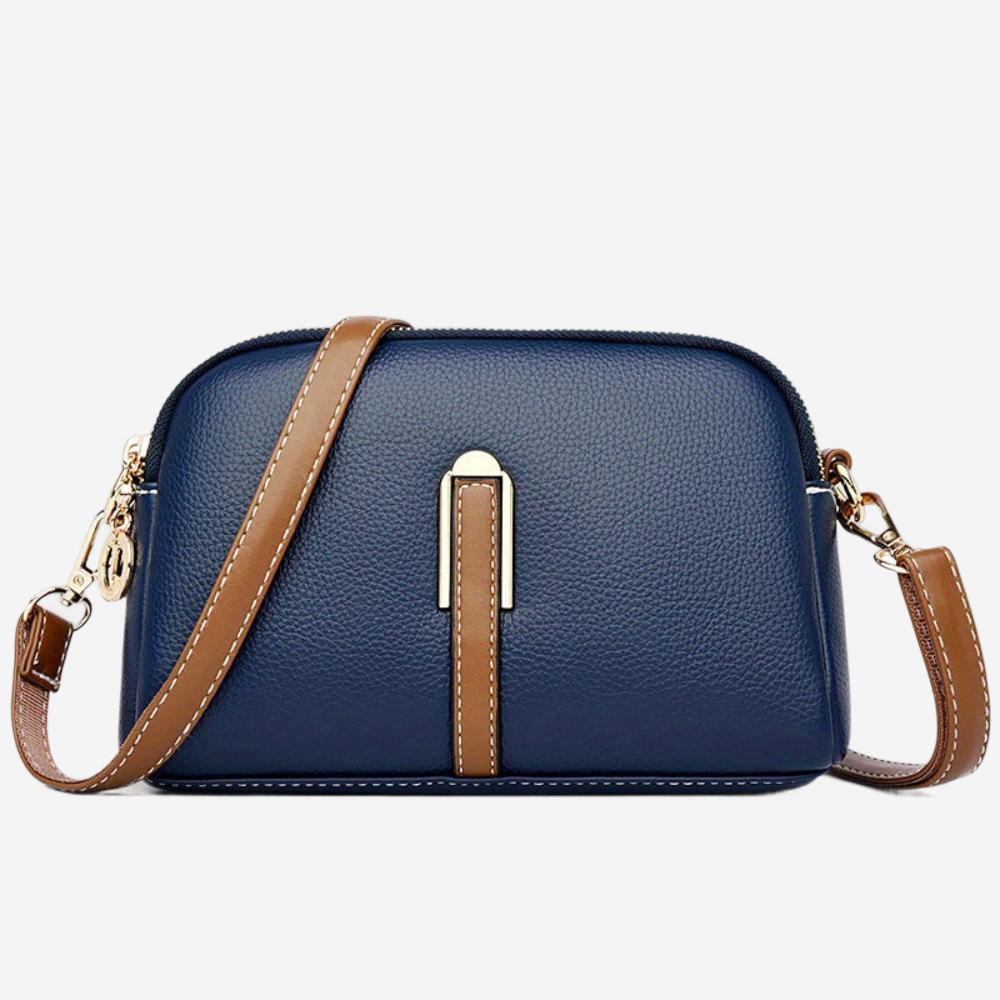 A navy blue crossbody bag with a brown leather strap and a gold-colored metal clasp.
