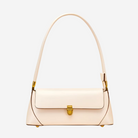 A cream-colored leather handbag with a gold-colored clasp and strap.