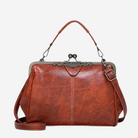 A brown leather handbag with a metal clasp and handle, featuring a distinctive design and texture.