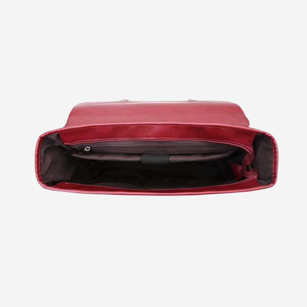 the interior of a red leather backpack or bag, with the zipper open and the interior visible.