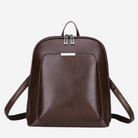 A brown leather backpack with a front pocket and two zippers on the top.