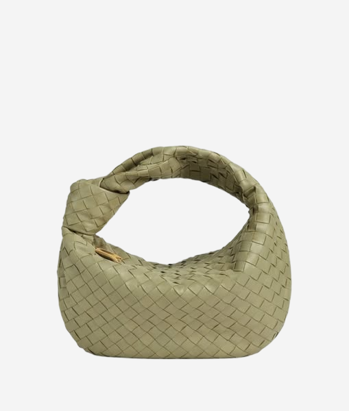 A small, light green woven purse with a distinctive knot detail.