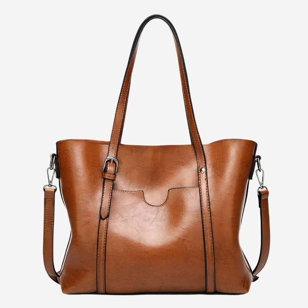 A brown leather tote bag with a curved handle and two shoulder straps.