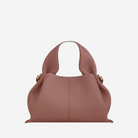 A brown leather handbag with a curved handle and two gold-colored buckles.