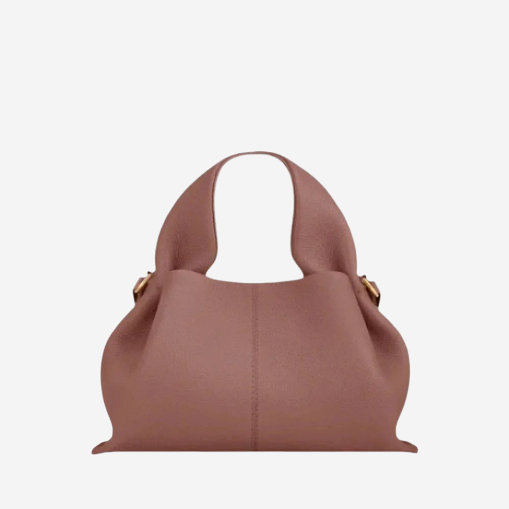A brown leather handbag with a curved handle and two gold-colored buckles.