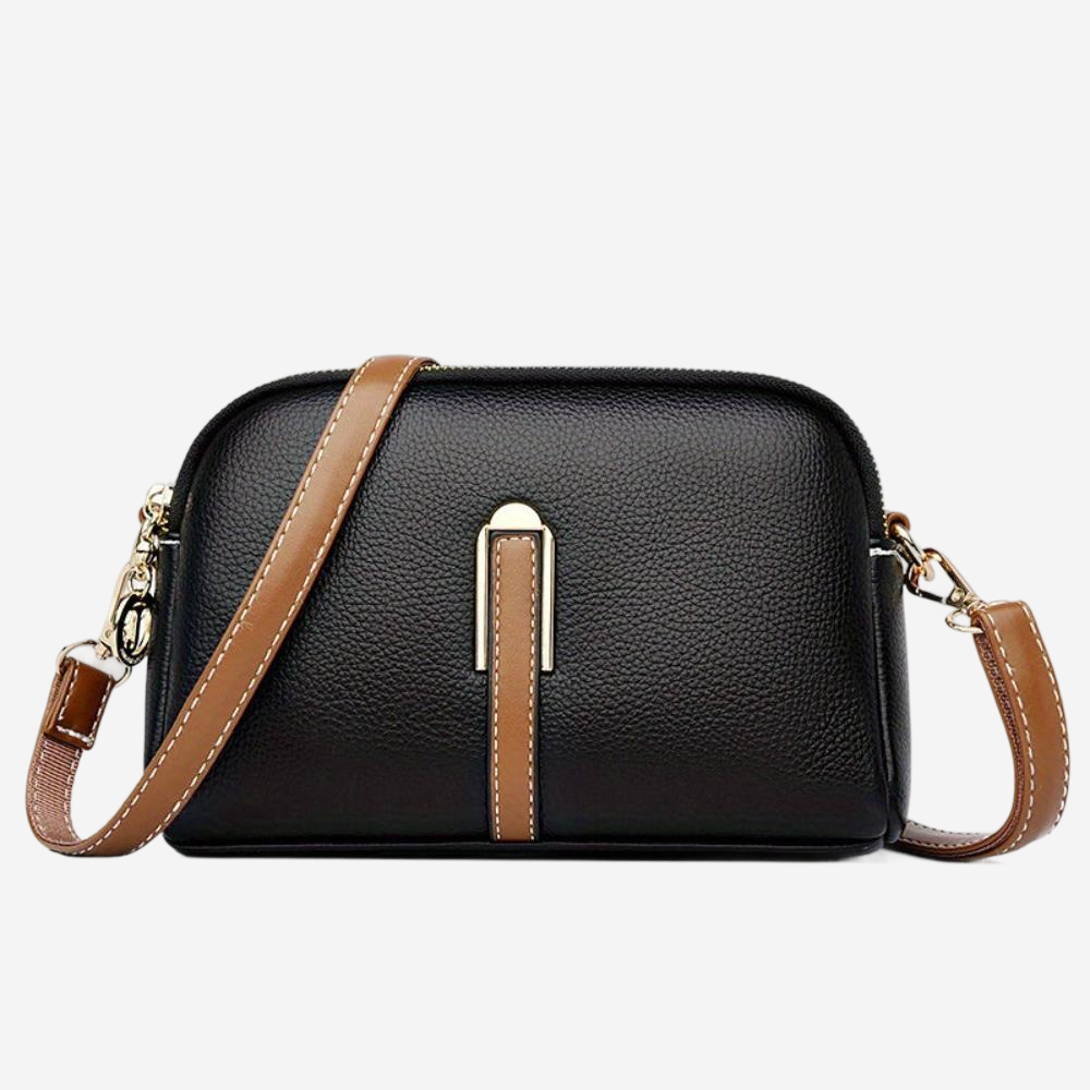 A black leather crossbody bag with a brown leather strap.